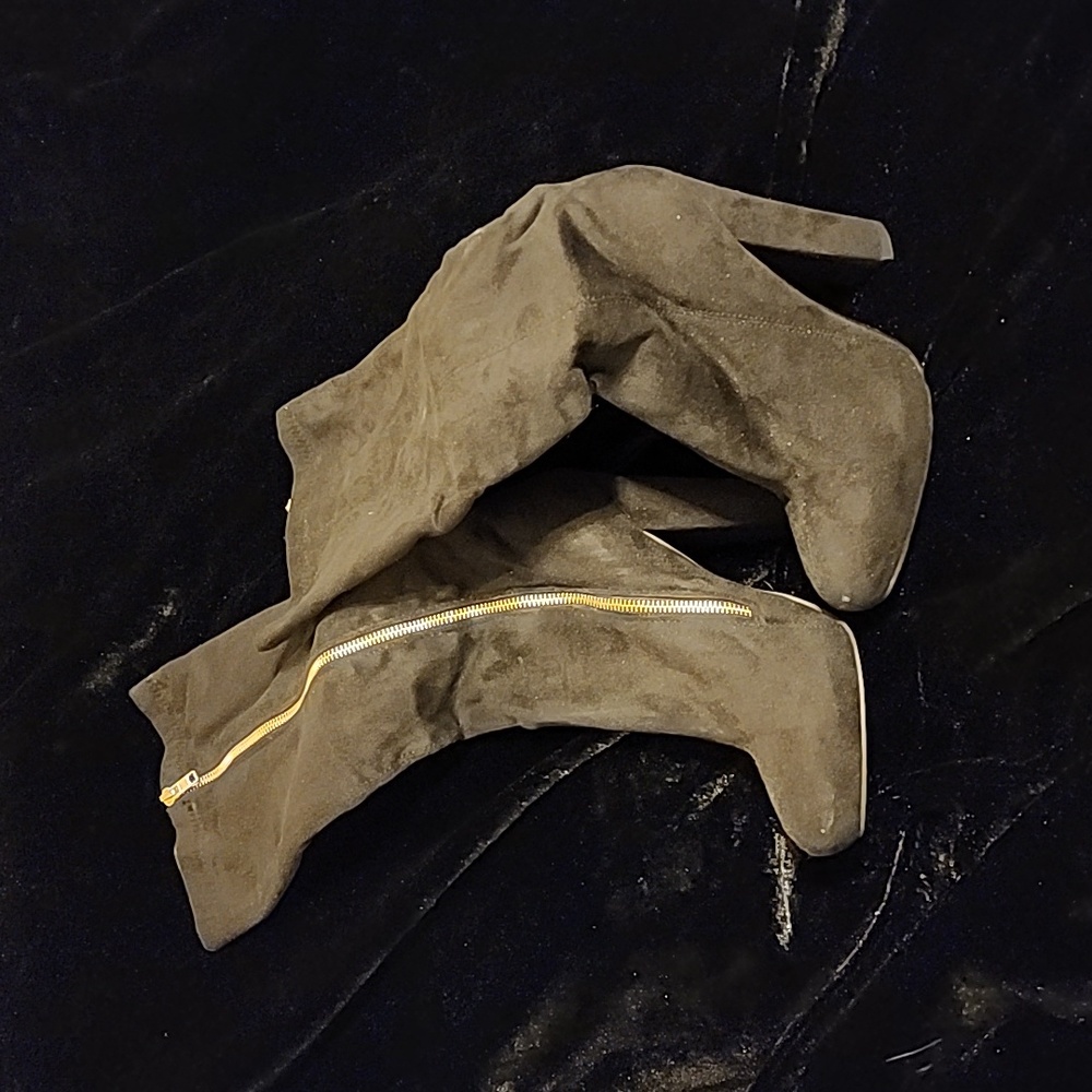 Black heeled boots with gold zipper